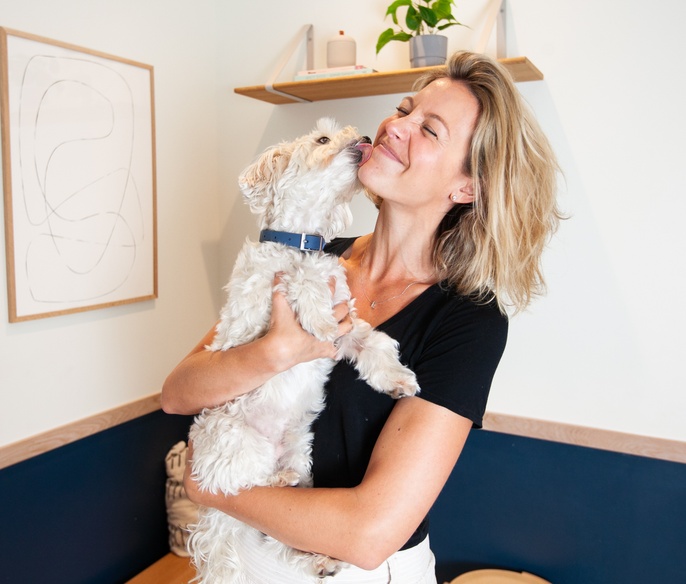Pet parent and pet snuggling in exam room
