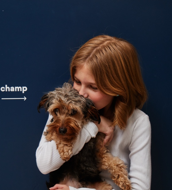 Dog and child cuddling at Bond Vet